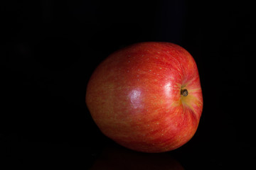 red apple on black background