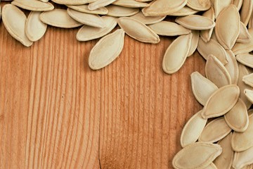 Wall Mural - Pumpkin seeds on wood