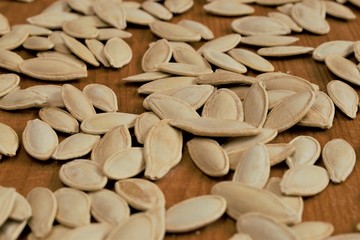 Pumpkin seeds on wooden board