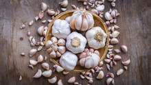 Top View Close Up, Garlic Bulbs In Wooden Basket For Cooking Background , Copy Space For Your Text
