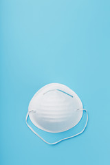 Wall Mural - Round face mask on a blue background. Virus protection Isolate