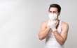 © ztony1971 - Portrait of panic man feeling sick wearing mask and holding his throat, panic and stress and scare of infected coronavirus (covid-19) pandemic, social distancing, self-quarantine with copy space.