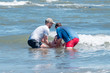 A public baptism by full immersion in the North Sea - girl child baptised by church leaders