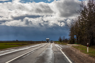 Truck on a country road on a spring cloudy day