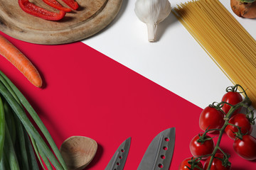 Poland flag on fresh vegetables and knife concept wooden table. Cooking concept with preparing background theme.