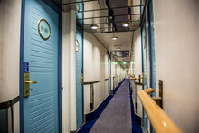 A Long Corridor In Blue Style With Cabin Doors On The Deck Of A Modern Passenger Ferry