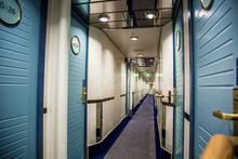 A Long Corridor With Cabin Doors On The Deck Of A Modern Passenger Ferry