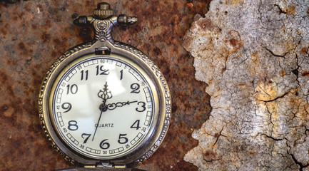 Vintage pocket watch showing time with textured background. concept of time