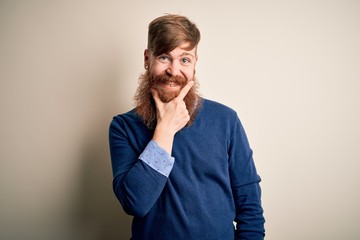 Poster - Handsome Irish redhead business man with beard standing over isolated background looking confident at the camera smiling with crossed arms and hand raised on chin. Thinking positive.