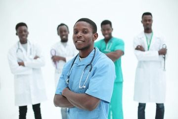 Wall Mural - young medic standing in front of his friends colleagues