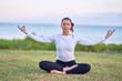 © Krakenimages.com - Young beautiful sportwoman practicing yoga. Coach sitting teaching lotus pose at park