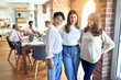 © Krakenimages.com - Beautiful businesswomen smiling happy. Standing with smile on face speaking taking rest at the office