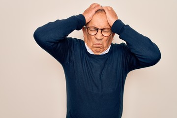 Sticker - Senior handsome grey-haired man wearing sweater and glasses over isolated white background suffering from headache desperate and stressed because pain and migraine. Hands on head.