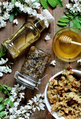 Wall Mural - products from white acacia - honey, syrup from acacia, jam, acacia flowers in batter. view from above. organic food from nature. natural habitat. Edible flowers. Flatlay