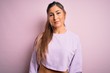 © Krakenimages.com - Young beautiful sport woman wearing sweatshirt over pink isolated background Relaxed with serious expression on face. Simple and natural looking at the camera.