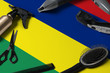 Mauritius flag with hair cutting tools. Combs, scissors and hairdressing tools in a beauty salon desktop on a national wooden background.