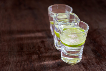 water with lemon are in the glass