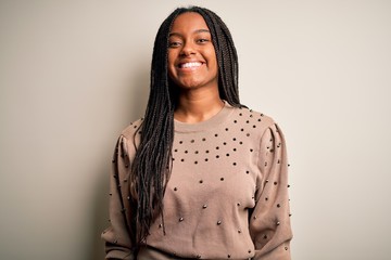 Young african american fashion woman standing casual over brown isolated background with a happy and cool smile on face. Lucky person.