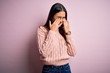 © Krakenimages.com - Young beautiful brunette woman wearing casual sweater over isolated pink background rubbing eyes for fatigue and headache, sleepy and tired expression. Vision problem