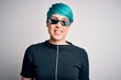 © Krakenimages.com - Young woman with blue fashion hair wearing thug life sunglasses over white background with a happy and cool smile on face. Lucky person.