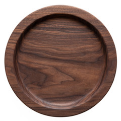 Sticker - Handmade black walnut round wood plate. Walnut round wooden tray. Black walnut wood plank texture background.