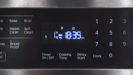 Close up of oven display flickering, control panel blinking. Electricity problem.