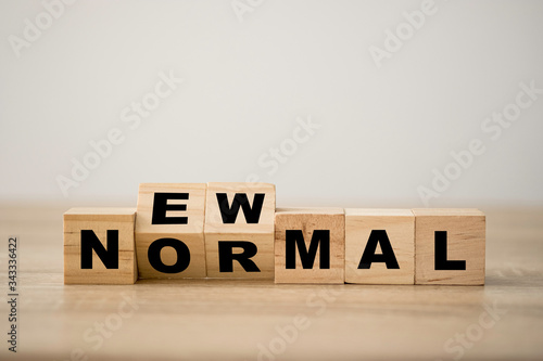 Fotografía Hand flipping wooden block cubes for new normal wording