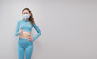 © reddish - Fitness girl  wearing medicine mask in fitness costume  isolated on grey costume. Training during quarantine, cover 19, corona virus.