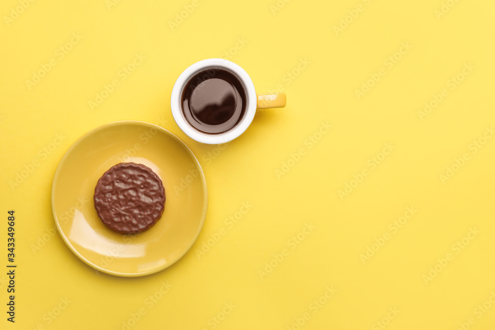 Cup of coffee with cookie on color background