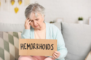 Sticker - Elderly woman with hemorrhoids at home