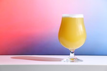 A Hazy New England India Pale Ale Beer In A Tulip Shaped Glass Against A Soft Background.