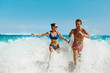 © puhhha - Couple Fun On Beach. Romantic People In Love Running On Sand At Luxury Sea Resort. Handsome Happy Man, Beautiful Smiling Woman Laughing Together On Summer Travel Vacation. Relationships, Summertime