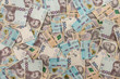 © RomanR - seamless texture of real new ukraine 500 and 1000 banknotes. Pile of hryvnia as financial background.