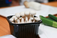 White Beech Mushroom Inside A Black Plastic Box In The Kitchen.