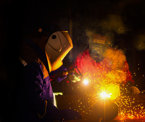 Industrial Worker at the factory welding closeup