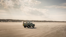 Terschelling, Holland - 8 March 2020: Land Rover Defender On North Sea Beach. The Iconic And Legendary Land Rover Defender Was Issued In 1983.