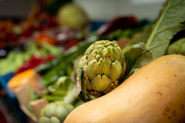 Artichoke and different vegetables in a vegetable shop