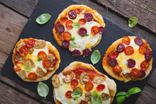 Homemade Mini Pizza With Mushrooms, Cheese And Sausages