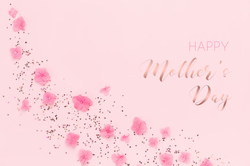 Wall Mural - Happy Mothers Day greeting card with pink flowers and gold confetti on pink background. Spring Holidays, Flat lay.