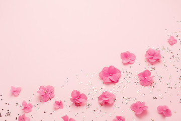 Wall Mural - Pink flowers and gold confetti for Happy Mothers Day greeting card. Holiday background, copy space. Spring, summer, birthday.