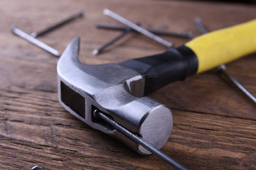 Poster - Hammer iron,centimeter tape and nails on wooden background