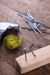 Poster - Hammer iron,centimeter tape and nails on wooden background