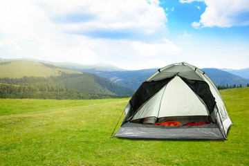 modern camping tent in mountains on sunny day