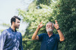 © chokniti - Old father and adult son are relaxing in the backyard
