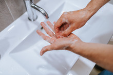 Close Up Of Caucasian Man Washes His Hands In The Bathroom. COVID - 19 Prevention