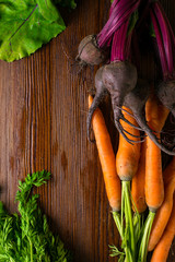 Wall Mural - organic beetroots and carrots on rustic wooden background