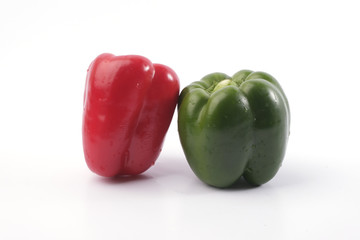 Wall Mural - Green and red bell pepper on white background