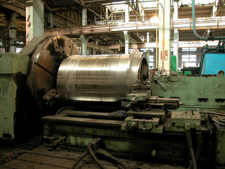 Industrial lathe. Metal processing. Sharpen. Factory pattern. Heavy industry background. Metallurgical plant concept.