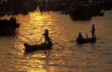 High Angle View Of Fishermen Rowing Boats In River During Sunset