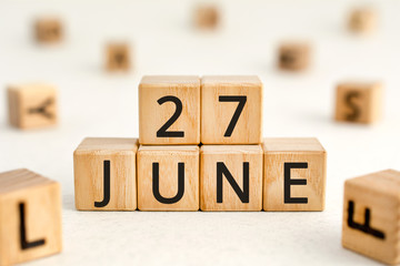 June 27 - from wooden blocks with letters, important date concept, white background random letters around